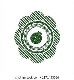 Green bomb icon inside rubber grunge seal