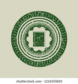Green book icon inside distress rubber stamp