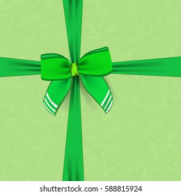 Green bow with the edge strips for Saint Patrick's day. Vector green decorative bow on a ribbon. Festive ribbon bow on green background - greeting card for traditional irish holiday