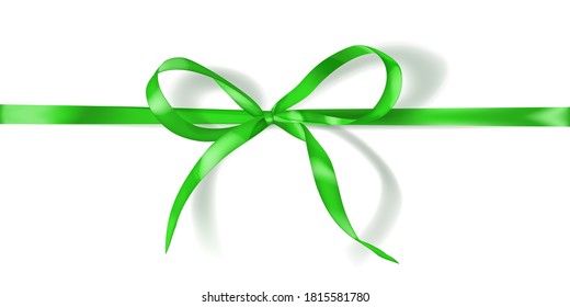 Green bow made of narrow ribbon with shadow on white background. Horizontal arrangement