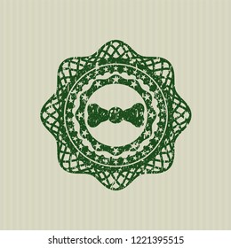 Green bow tie icon inside distressed grunge stamp