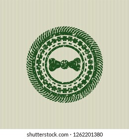 Green bow tie icon inside distress rubber grunge stamp