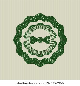 Green bow tie icon inside distress rubber seal with grunge texture