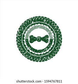 Green bow tie icon inside distress with rubber seal texture