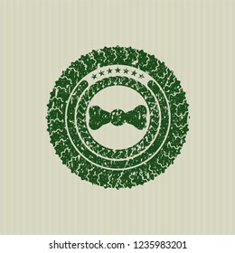 Green bow tie icon with rubber seal texture