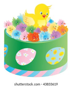 Green box with little of different colors toy chickens and one real chicken