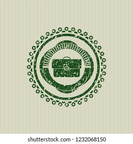 Green briefcase icon inside distressed rubber grunge texture seal
