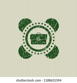 Green briefcase icon inside rubber seal