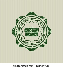 Green briefcase icon inside rubber grunge stamp