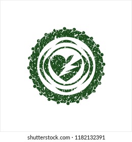 Green broken heart icon inside distressed rubber grunge seal