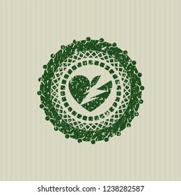 Green broken heart icon inside distress rubber grunge texture stamp