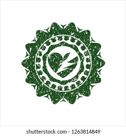 Green broken heart icon inside distressed with rubber seal texture