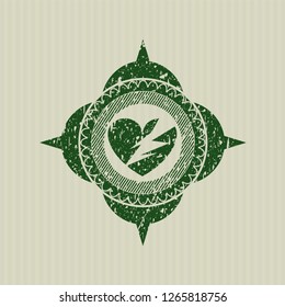 Green broken heart icon inside distressed rubber grunge seal