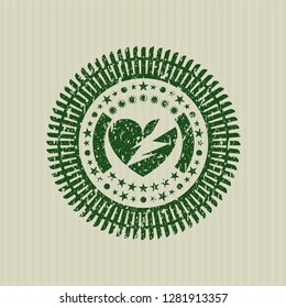Green broken heart icon inside distressed rubber grunge texture stamp