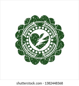 Green broken heart icon inside distress rubber grunge texture stamp