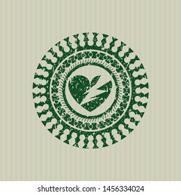 Green broken heart icon inside distressed rubber grunge seal