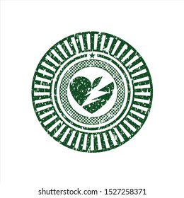 Green broken heart icon inside distress rubber grunge stamp