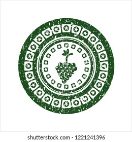 Green bunch of grapes icon inside distressed with rubber seal texture