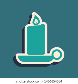 Green Burning candle in candlestick icon isolated on blue background. Old fashioned lit candle. Cylindrical candle stick with burning flame. Long shadow style. Vector Illustration