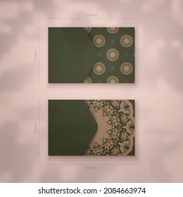 Green business card with abstract brown ornament for your personality.