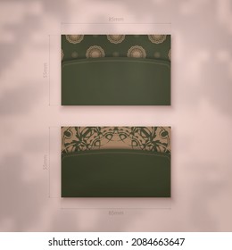 Green business card with brown mandala ornament for your business.