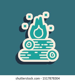 Green Campfire icon isolated on blue background. Burning bonfire with wood. Long shadow style. Vector Illustration