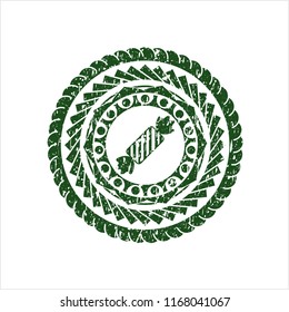 Green candy icon inside distress rubber grunge texture stamp