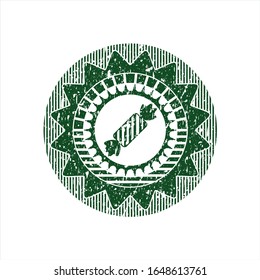 Green candy icon inside distress rubber grunge texture seal