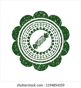 Green candy icon inside rubber grunge stamp