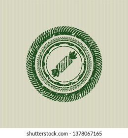 Green candy icon inside rubber grunge seal