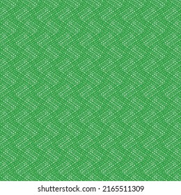 Grüne Leinwand mit einem Mosaikmuster, das durch einige Stiche verstärkt wird. Harte Textur.