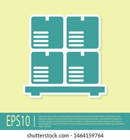 Green Cardboard boxes on pallet icon isolated on yellow background. Closed carton delivery packaging box with fragile signs.  Vector Illustration