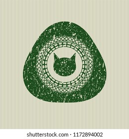 Green cat face icon inside rubber stamp with grunge texture