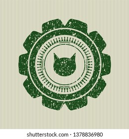 Green cat face icon inside distress rubber stamp with grunge texture