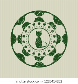 Green cat icon inside rubber seal with grunge texture
