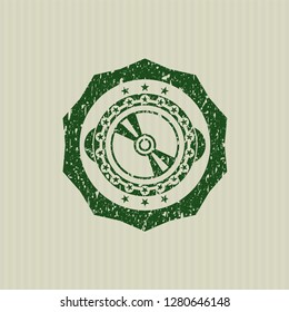 Green CD disc icon inside distressed rubber grunge stamp