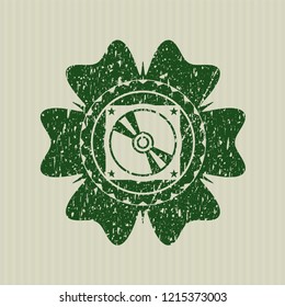Green CD or DVD disc icon inside rubber texture