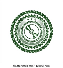Green CD or DVD disc icon inside distressed grunge seal