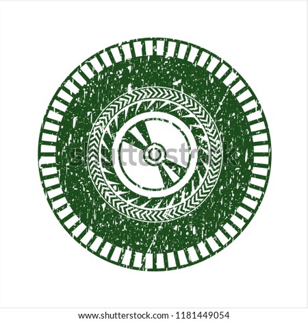 Green CD or DVD disc icon inside rubber texture
