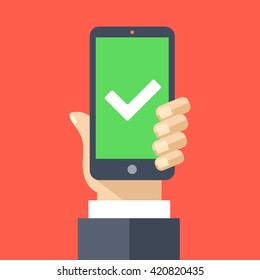 Green checkmark on smartphone screen. Hand holding smartphone. Mobile phone with white tick. Success concept. Modern design for web banners, web sites, infographics. Flat design vector illustration