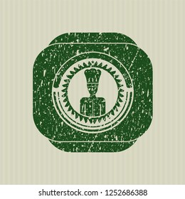 Green chef icon inside distressed with rubber seal texture