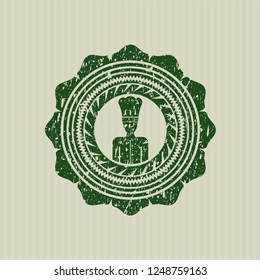 Green chef icon inside rubber seal with grunge texture