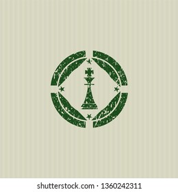 Green chess king icon inside distressed rubber grunge stamp