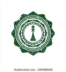 Green chess king icon inside rubber seal