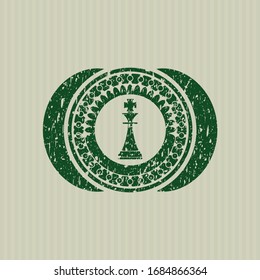 Green chess king icon inside distressed rubber seal