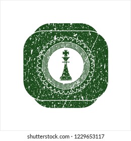 Green chess king icon with rubber seal texture