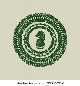 Green chess knight icon inside rubber stamp