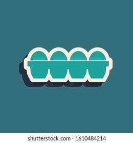 Green Chicken egg in box icon isolated on blue background. Long shadow style. Vector Illustration