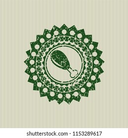 Green chicken leg icon inside rubber stamp