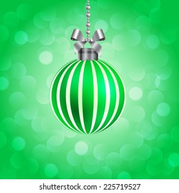 Green christmas ball on sparkling background.